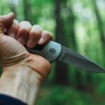 Using a survival knife and tactical light in the wild.